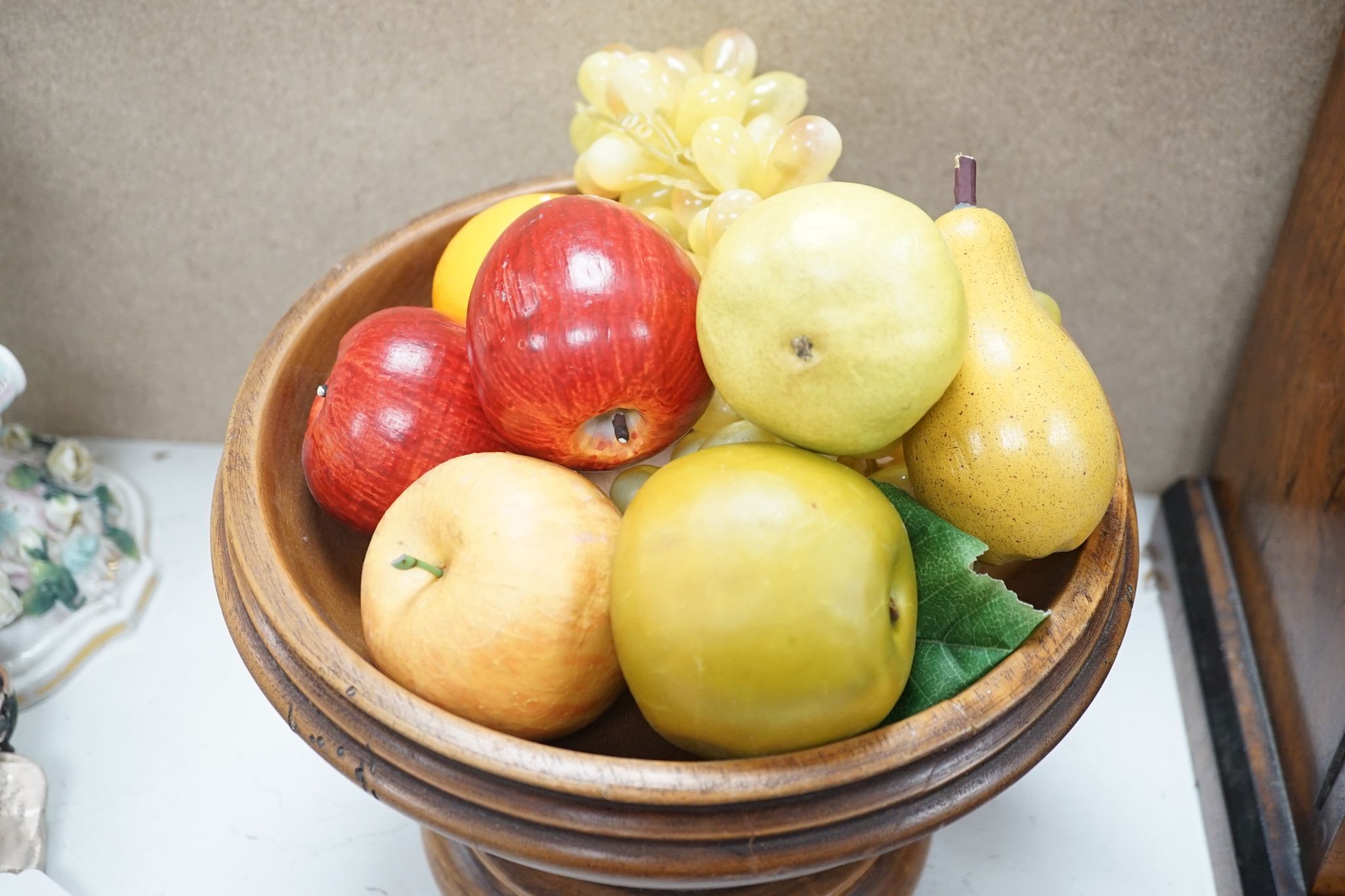 Faux fruit on a turned wood pedestal bowl